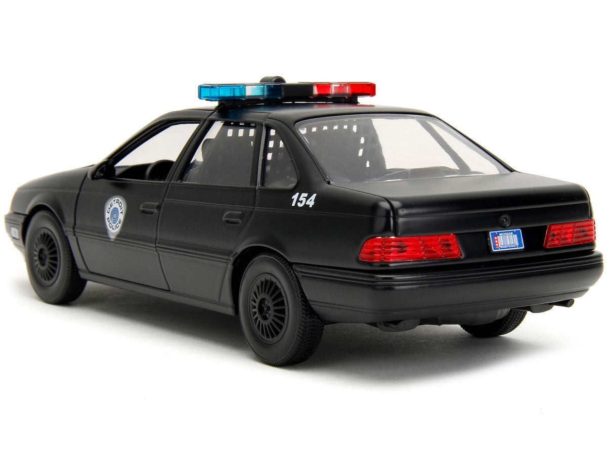 Ford Taurus OCP Matt Black "Detroit Police" and Robocop Diecast Figure 35th Anniversary "Robocop" (1987) Movie "Hollywood Rides" Series 1/24 Diecast Model Car by Jada